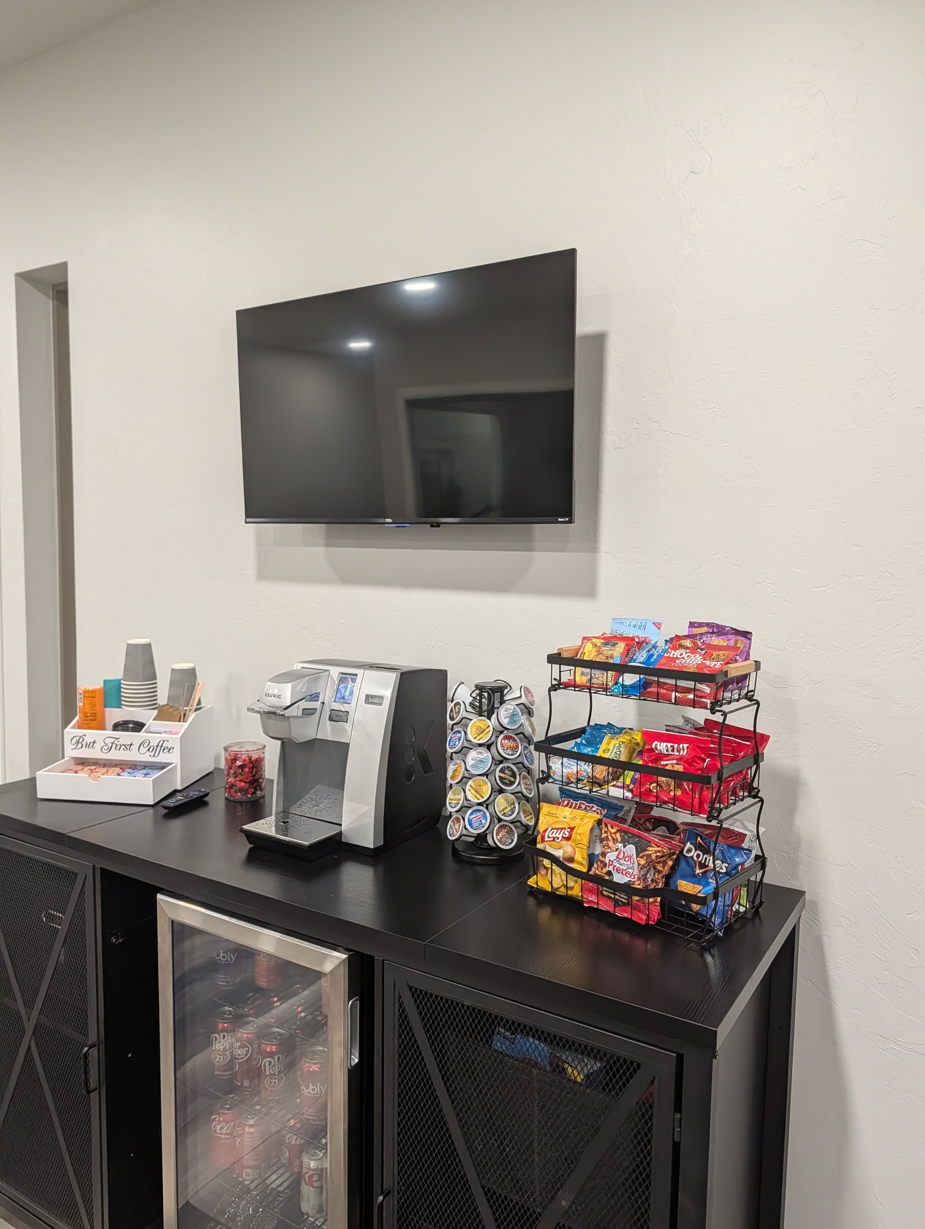 Break room TV above coffee station at Closed Title Edmond