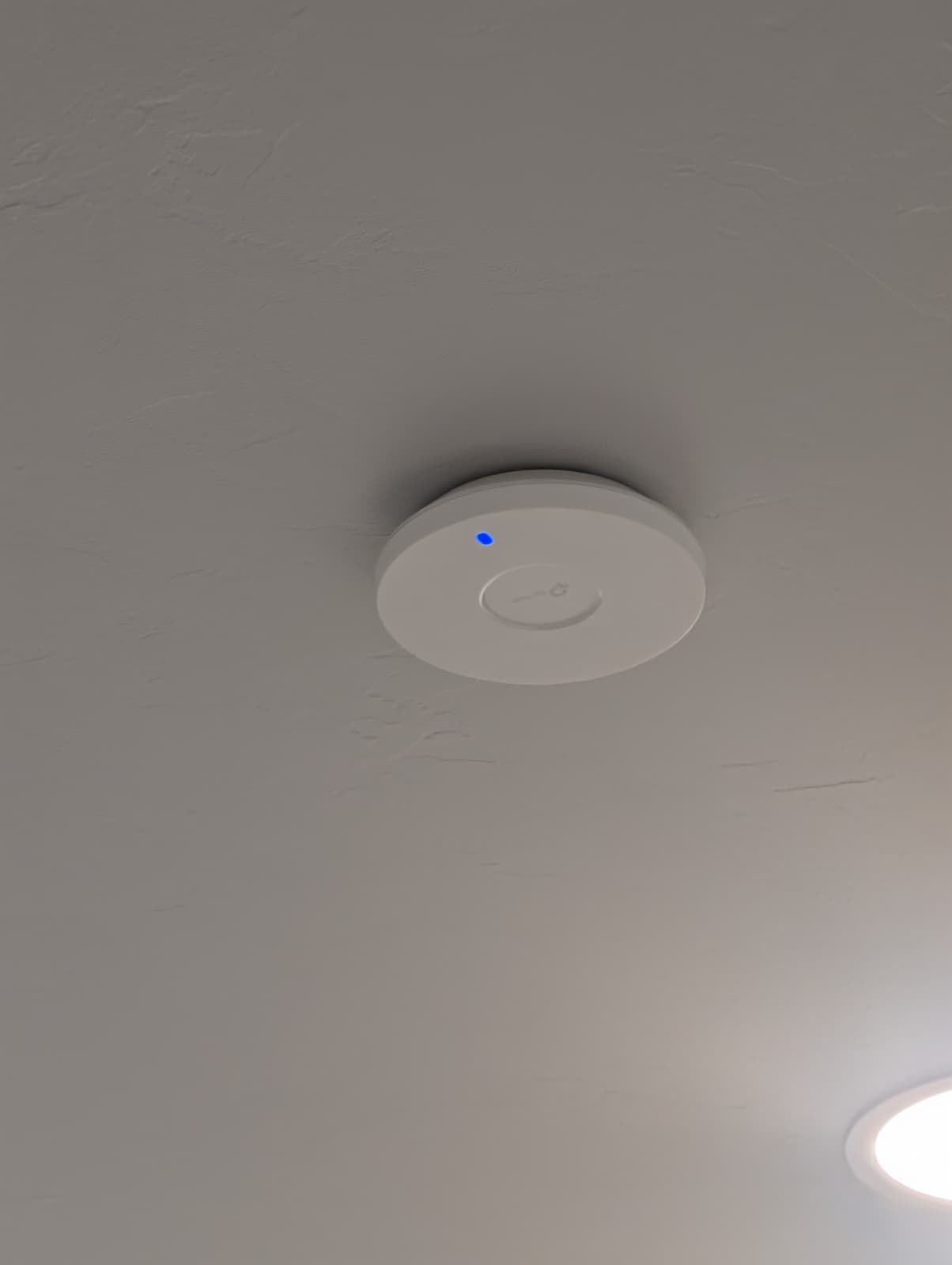 Ceiling-mounted UniFi access point at Closed Title Edmond